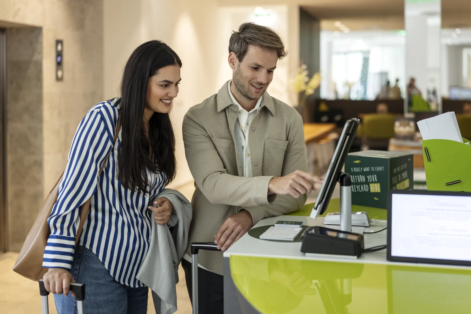 Guests checking into the hotel using a terminal.